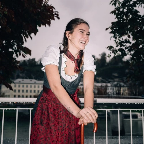 A cheerful moment in Salzburg, with a Hotel Sacher umbrella adding a signature touch of charm to a rainy day.
