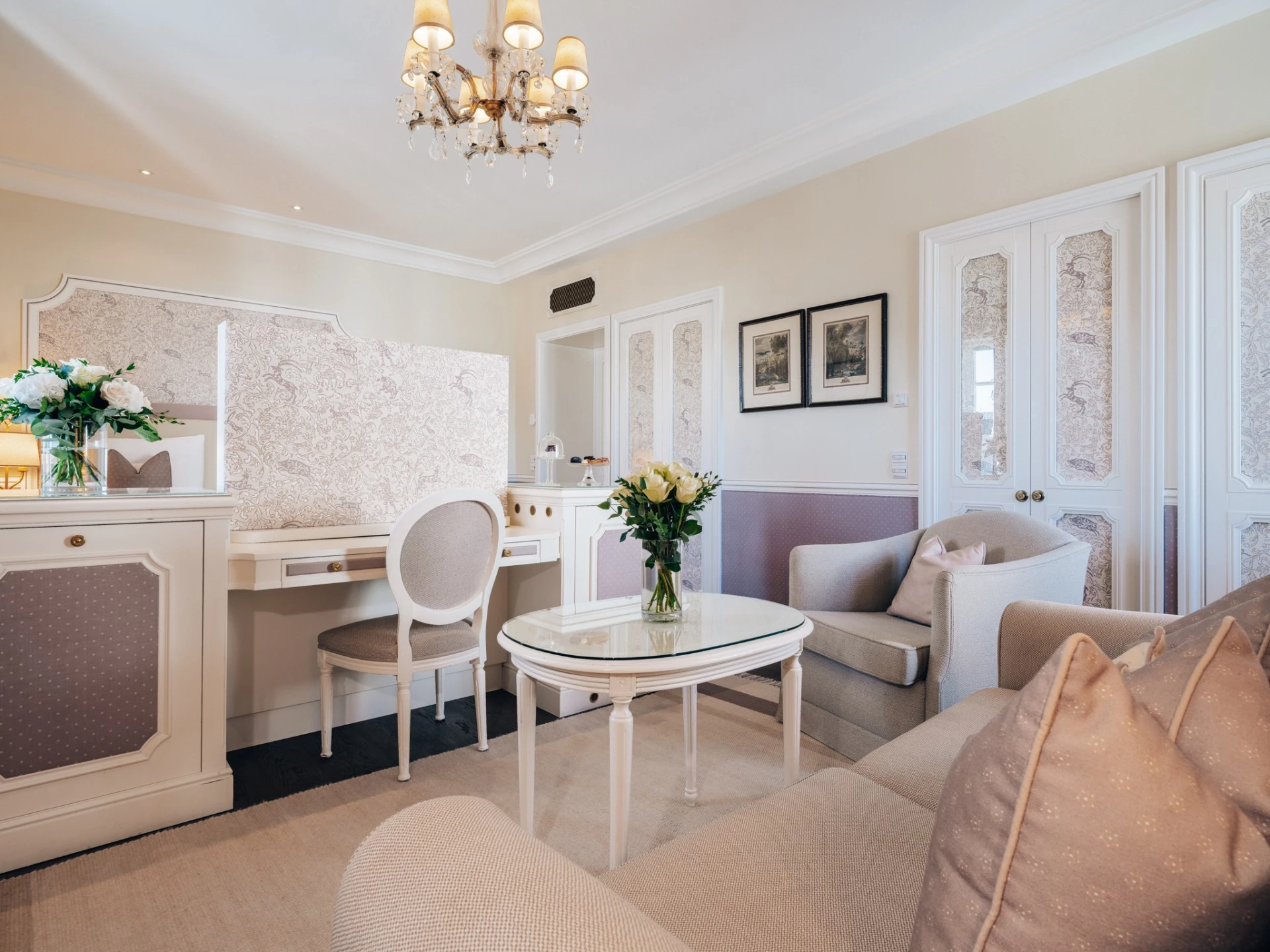 A pastel-toned sitting area at Hotel Sacher Salzburg exudes refined elegance with floral accents and classical charm.