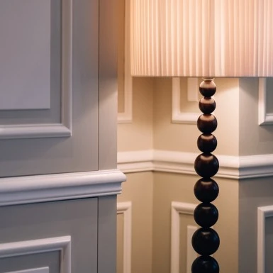 A warm, ambient glow from a sculptural floor lamp softly illuminates the classic paneled walls of a refined space in Hotel Sacher Salzburg.