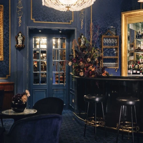 The opulent charm of the Blaue Bar at Hotel Sacher Wien, with its deep blue palette, ornate gold accents, and intimate old-world ambiance.