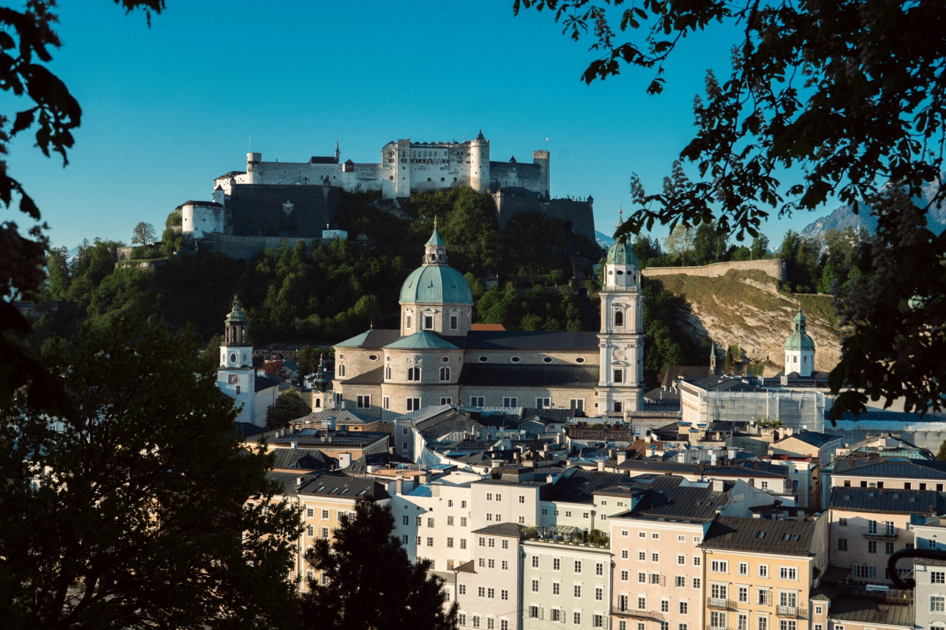 Group of houses seen from the Kapuziner mountain surrounded by green nature