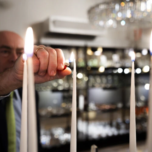 Close up of candles being lit.