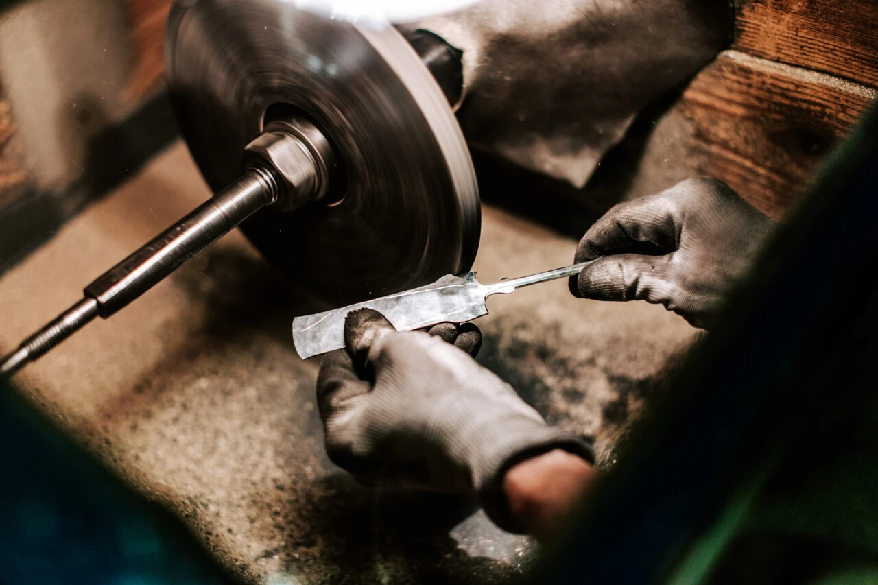 A close up of the a silver cutlery being made at the Vaugoin workshop