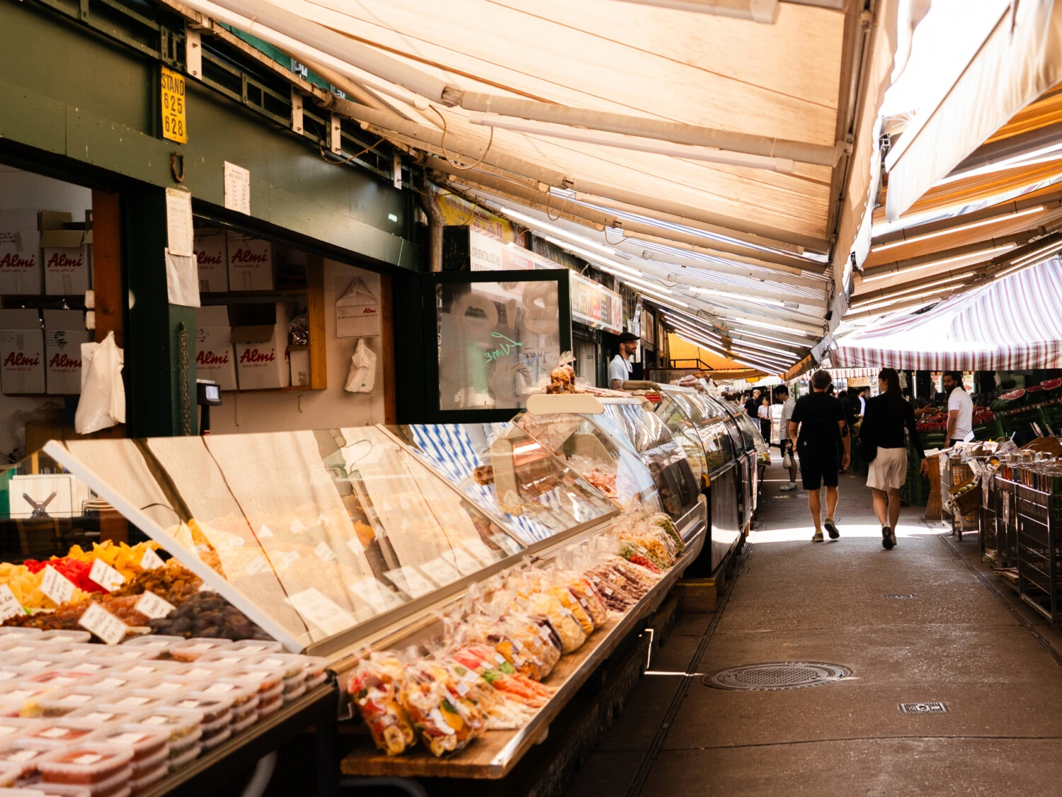 People walking through the Viennese Food market Naschmarkt