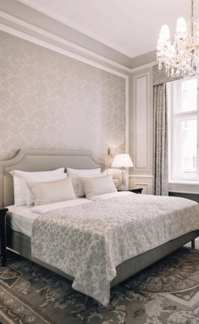 A beautiful hotel bedroom with a classic design and a sophisticated neutral color palette.