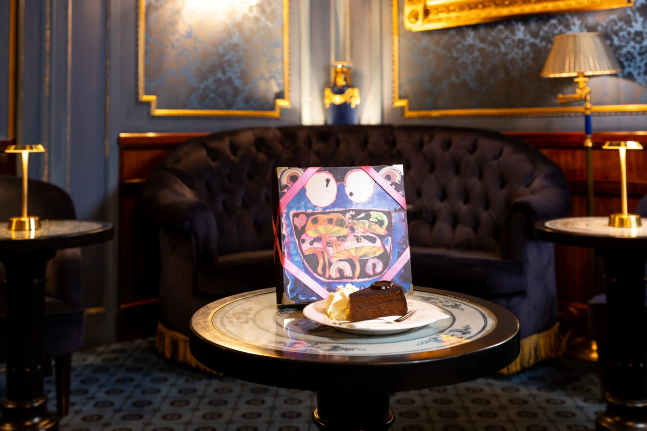 Limited Edition 2025 Sacher-Torte box displayed with a plated slice of the iconic cake