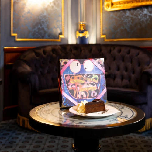 Limited Edition 2025 Sacher-Torte box displayed with a plated slice of the iconic cake