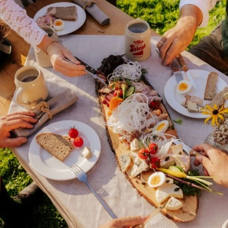 Traditional Salzburg Brettljausn with cheese, ham, eggs and vegetables – authentic Austrian cold platter enjoyed outdoors.