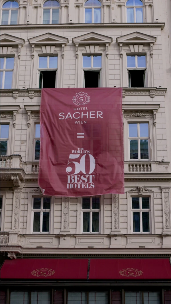 Historic Hotel Sacher Wien exterior with a banner celebrating its spot among the world's 50 best hotels.
