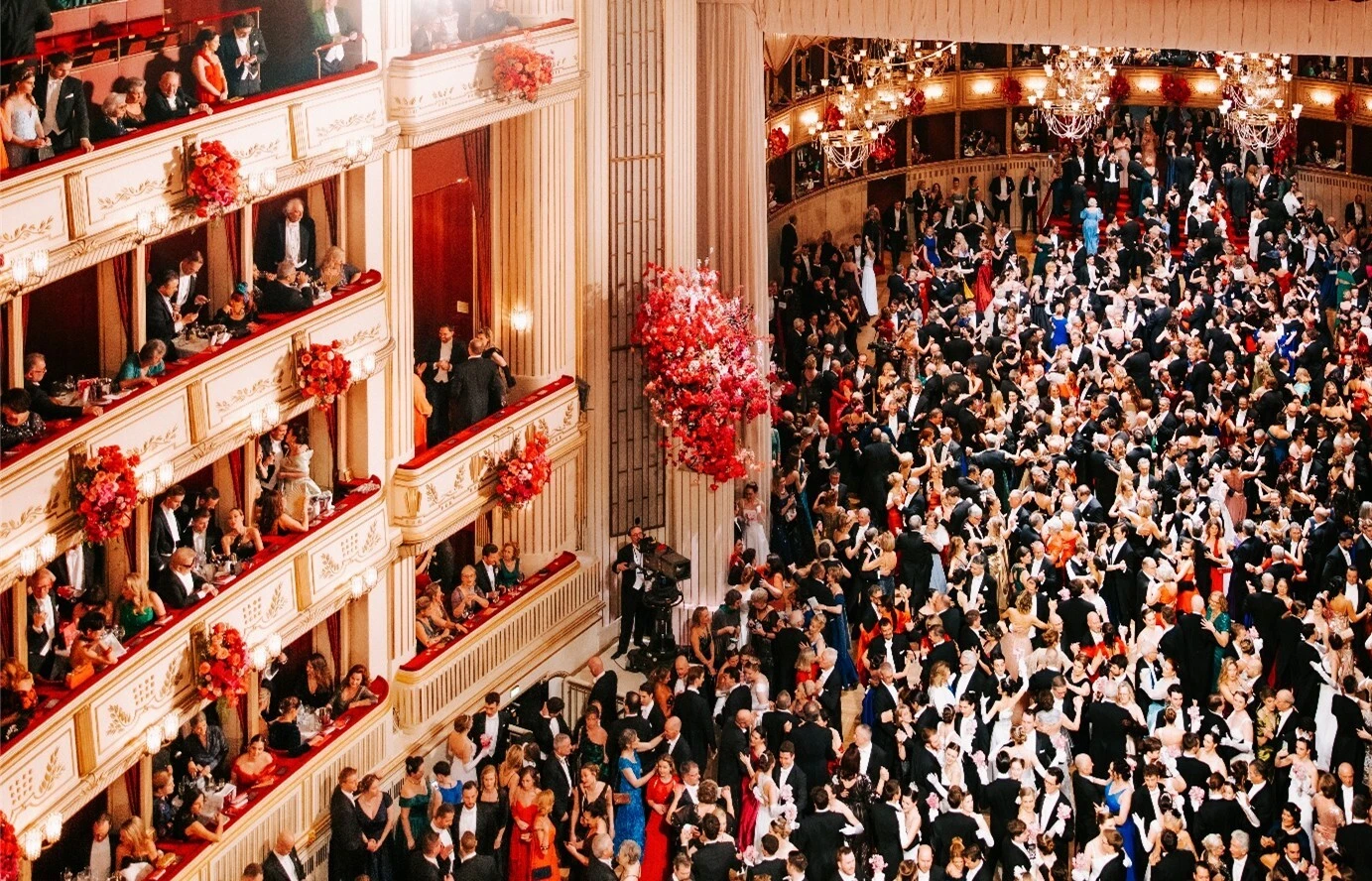 Ball night at the Vienna Opera Ball with elegant guests, tailcoats, and ball gowns in the grand ballroom