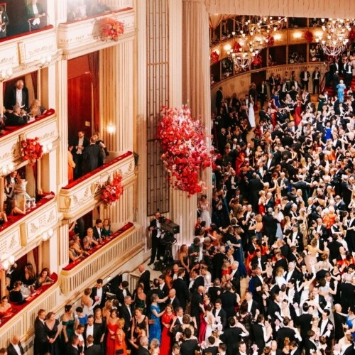 Ball night at the Vienna Opera Ball with elegant guests, tailcoats, and ball gowns in the grand ballroom