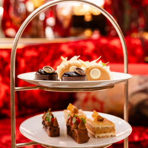 Afternoon Tea at Hotel Sacher featuring refined pastries, delicate sandwiches and an elegant presentation in a classic salon