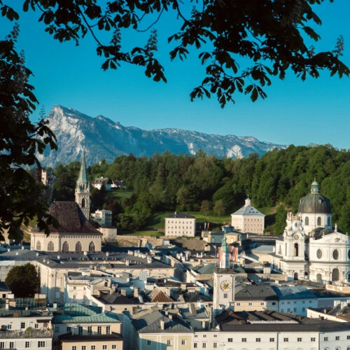 Panoramic view of Salzburg’s Old Town, featuring the fortress and the Alpine backdrop, a UNESCO World Heritage Site near the Hotel Sacher Salzburg