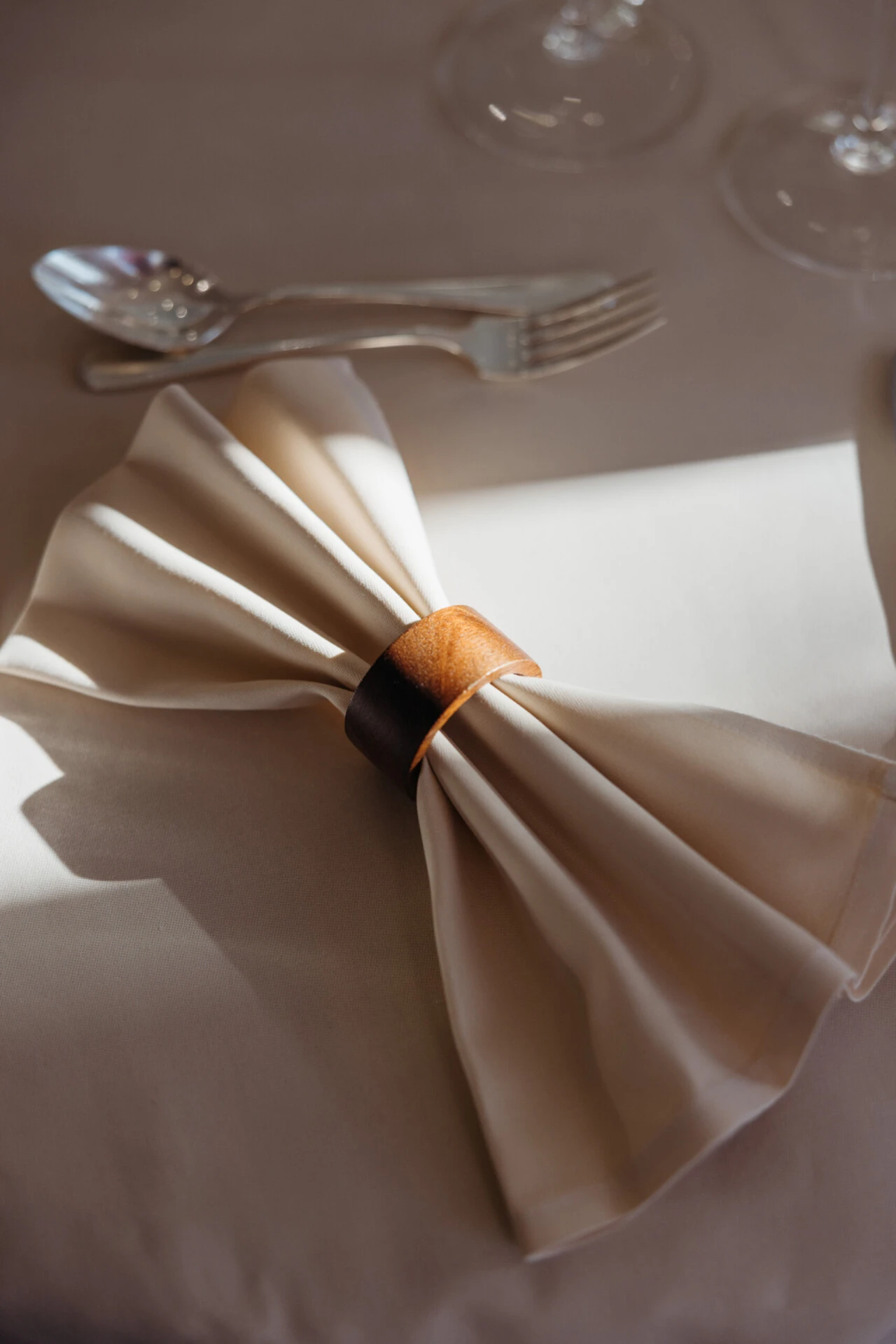 Fine dining table setting at Hotel Sacher Salzburg with wine glasses, folded napkins, silver cutlery and elegant table decor for private events.