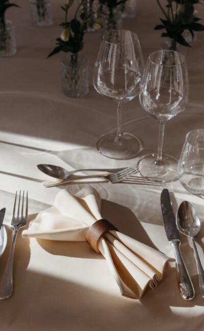Fine dining table setting at Hotel Sacher Salzburg with wine glasses, folded napkins, silver cutlery and elegant table decor for private events.