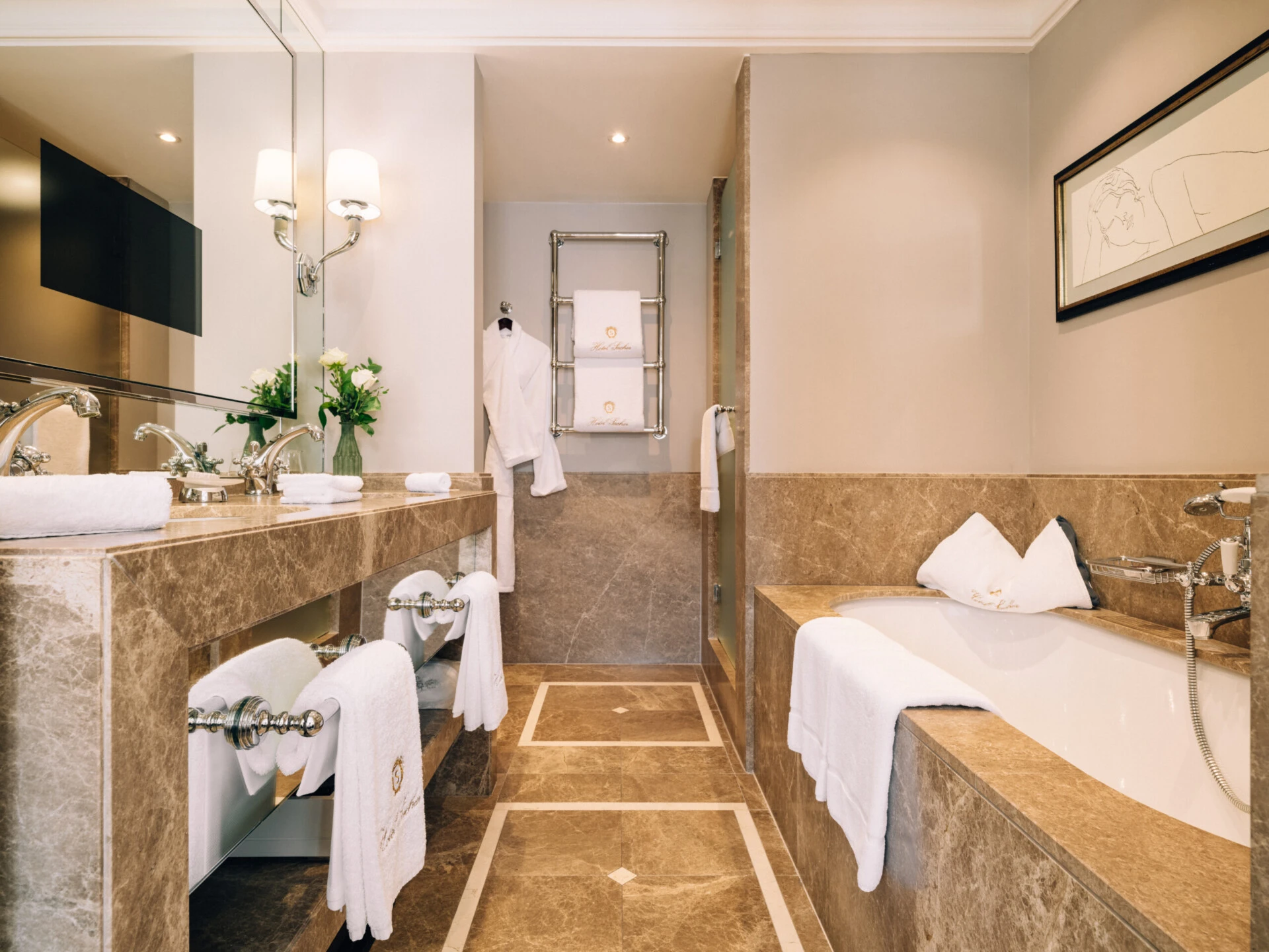 Marble bathroom in the Deluxe Room with View at Hotel Sacher Salzburg, featuring a bathtub, large mirror, double vanity and white towels