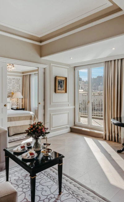 Living area of the Signature Suite with Balcony at Hotel Sacher Salzburg, featuring a sofa, elegant table and views of Salzburg