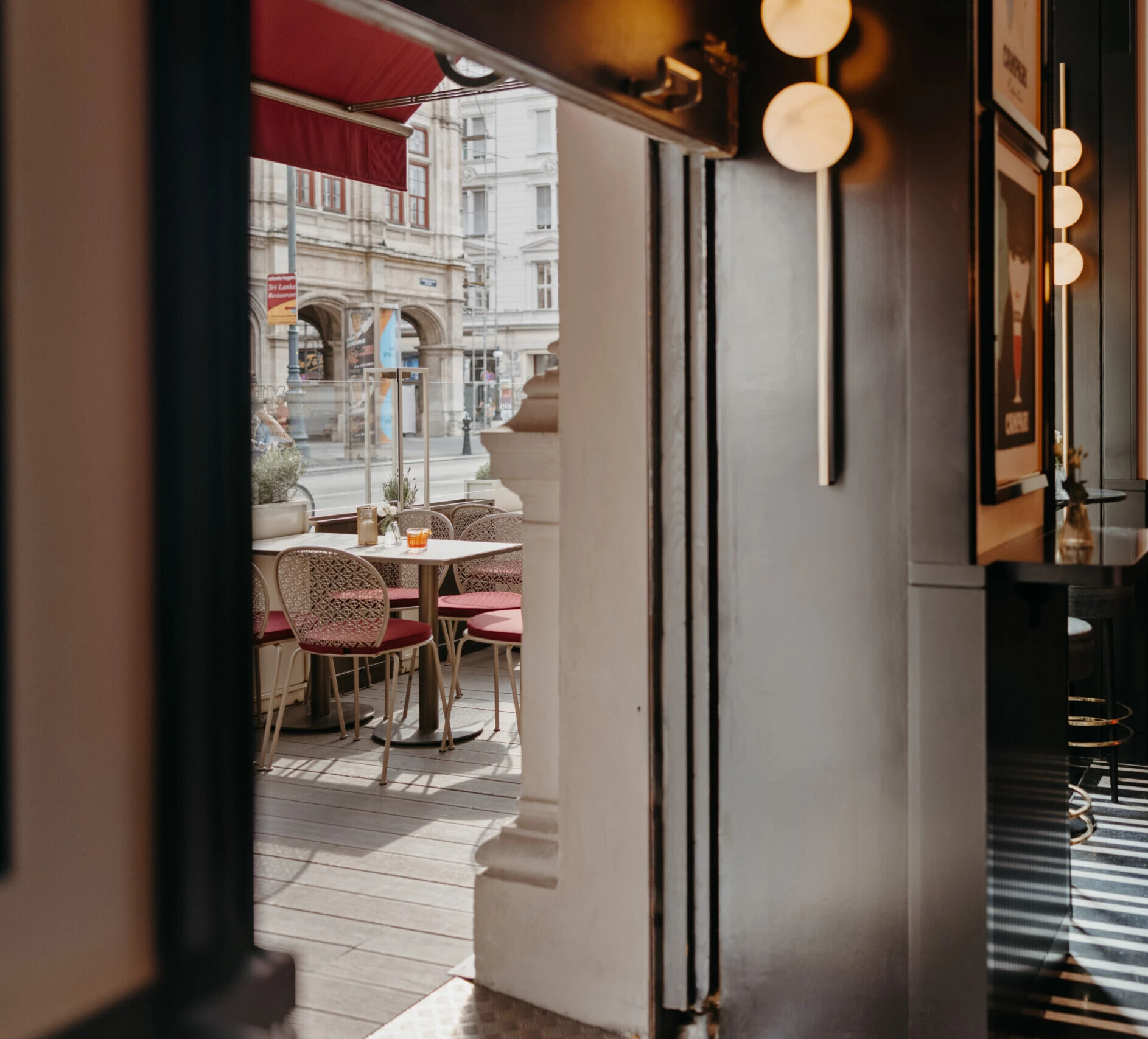 View from Salon Sacher onto the adjoining terrace with outdoor seating.