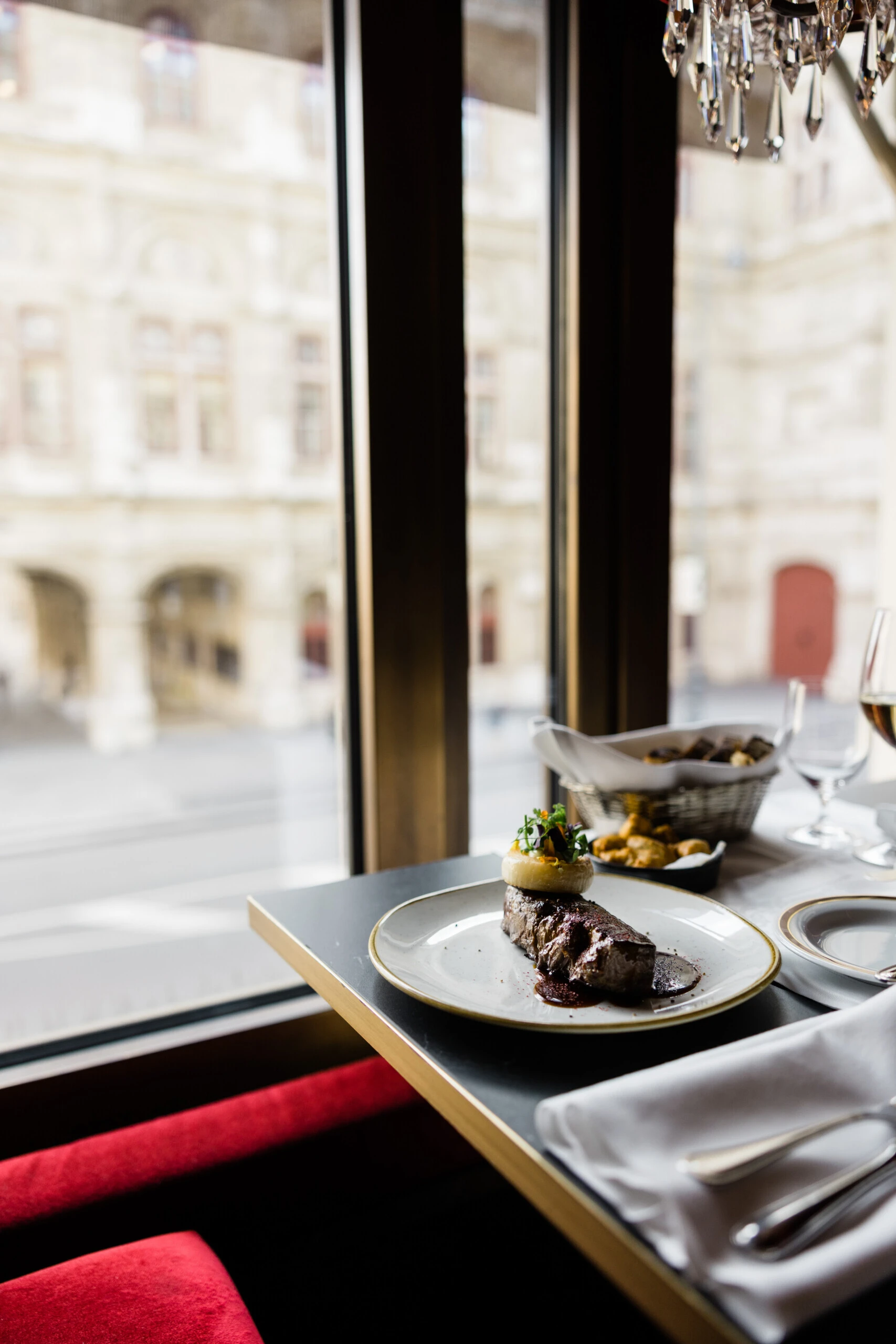 Main course served by the window at Café Bel Étage with a view of the Vienna State Opera.
