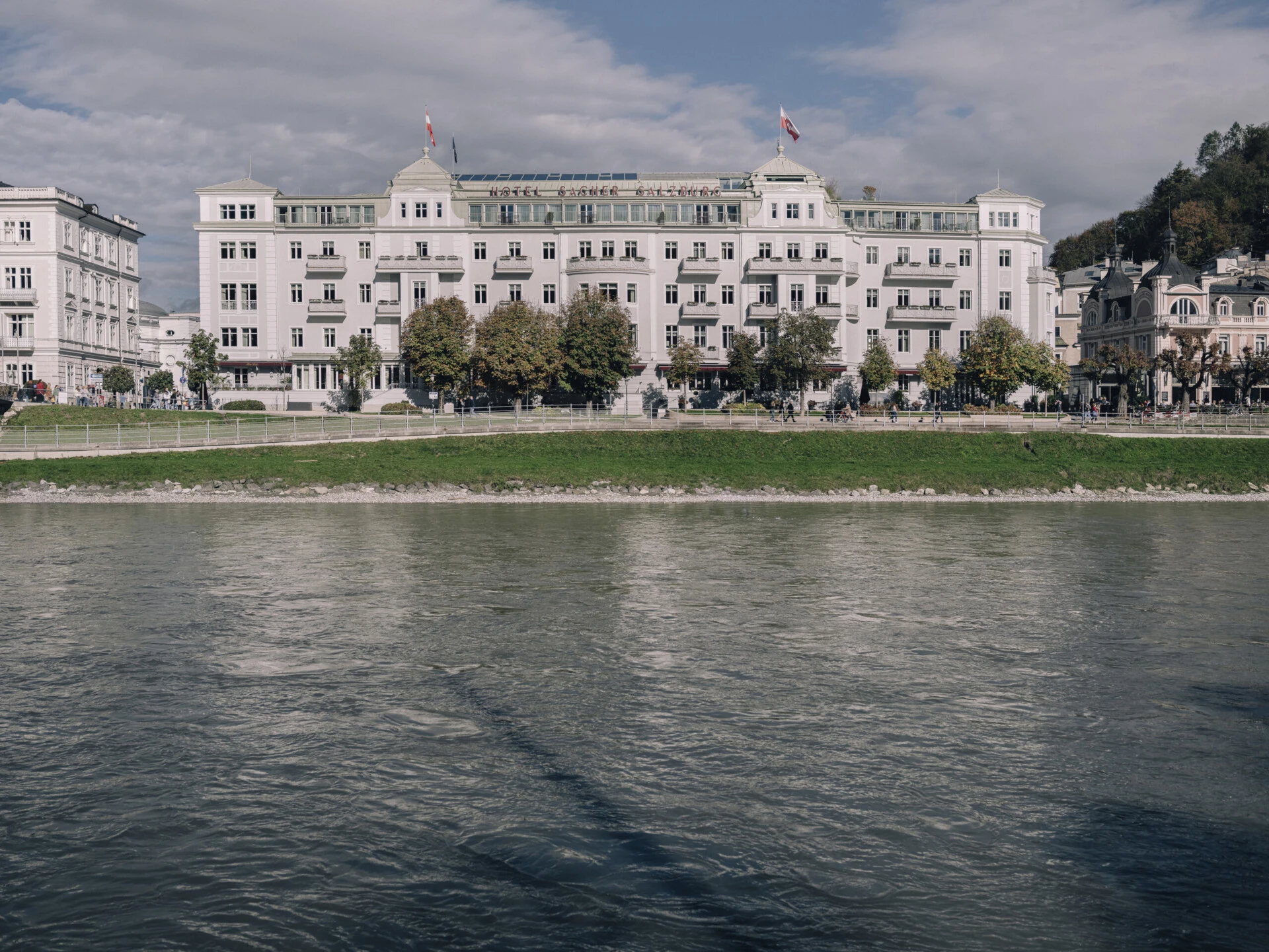 Front view of Hotel Sacher Salzburg directly on the Salzach River.