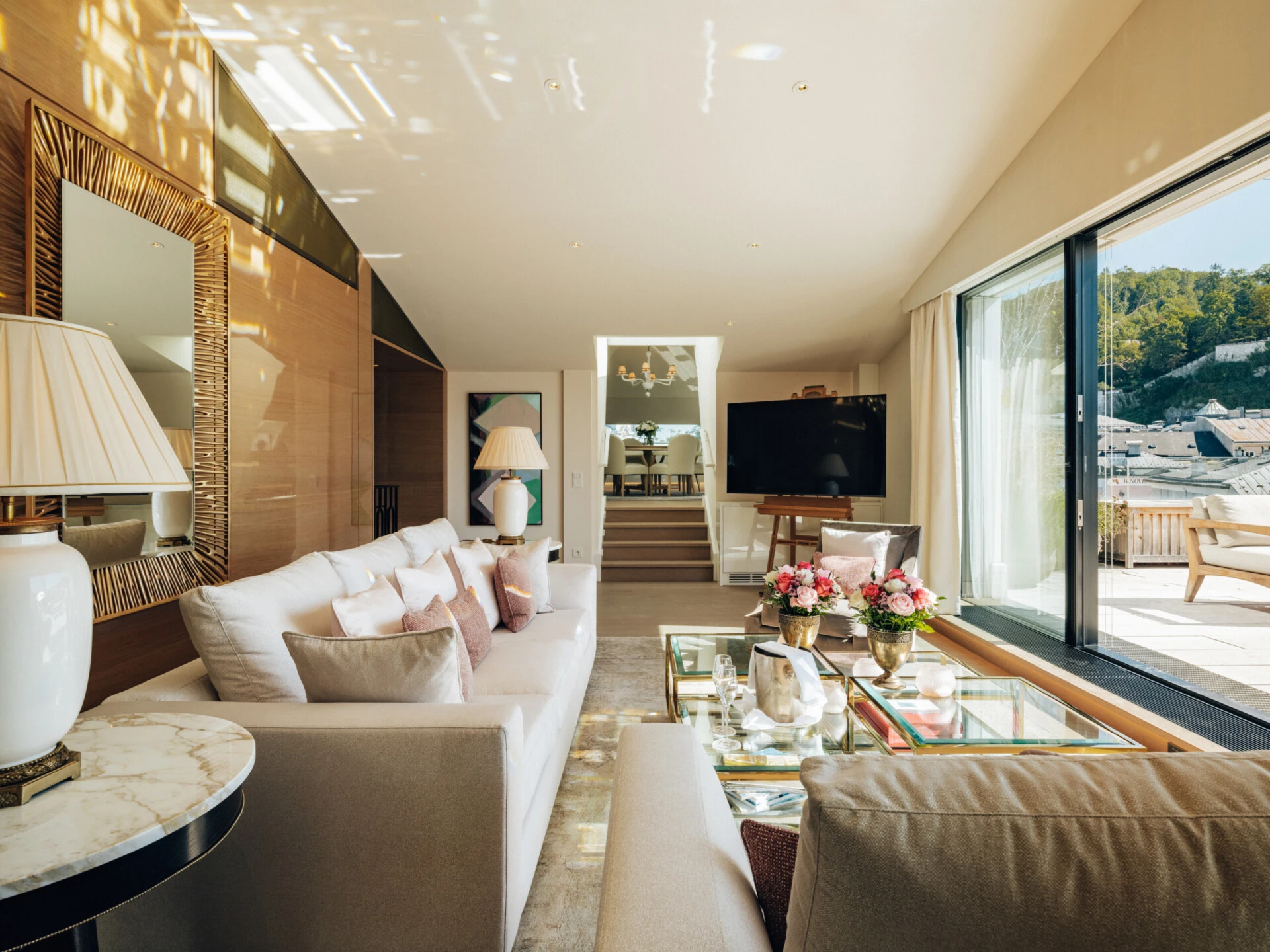Spacious living room of the Sky Suite with bright furnishings and terrace access.