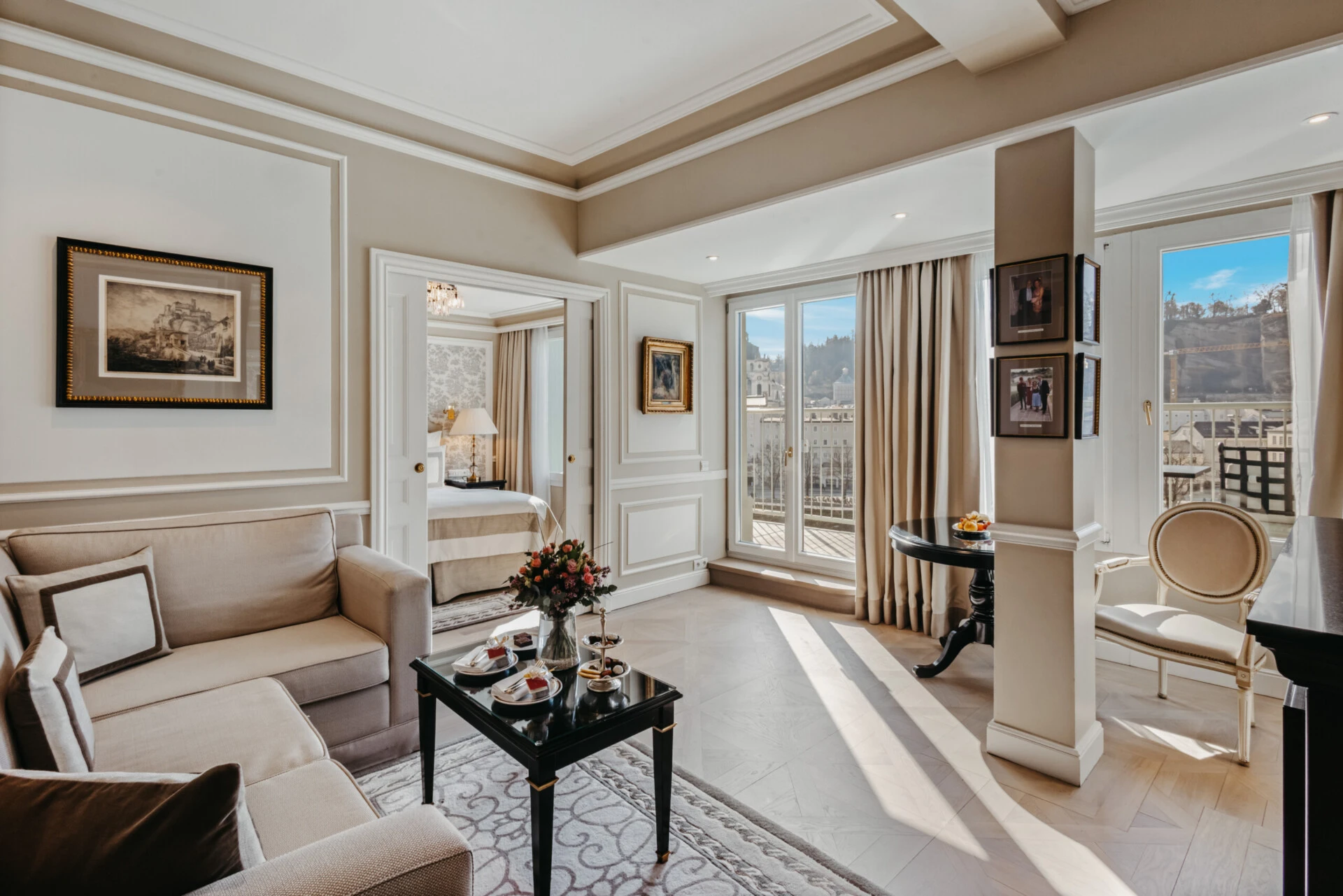 Bright living area of the signature suite with terrace access and views over Salzburg.