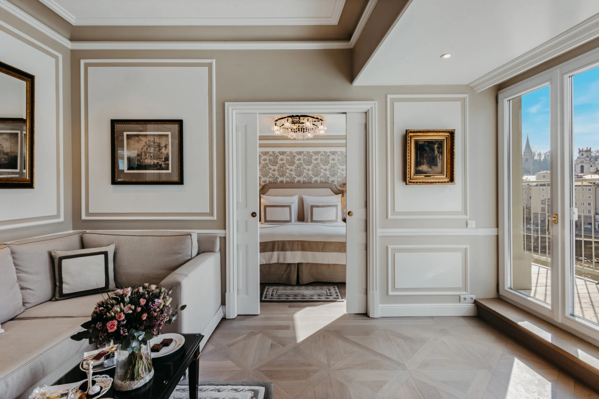 Bright signature suite at Hotel Sacher Salzburg with a living area, bedroom and city views.