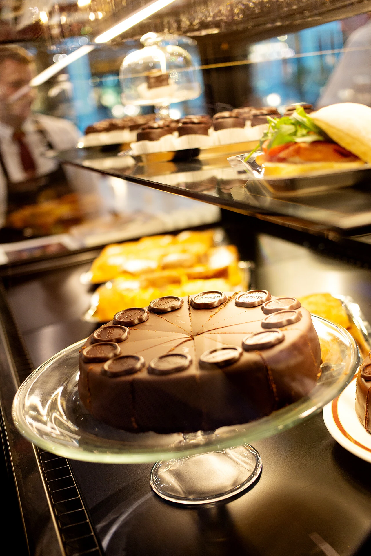Original Sacher-Torte and other dishes displayed at Sacher Eck Parndorf.