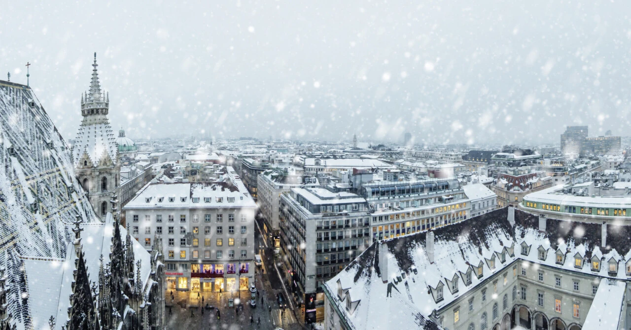 A snow-covered view of downtown Vienna with St. Stephen's Cathedral amid heavy snowfall.