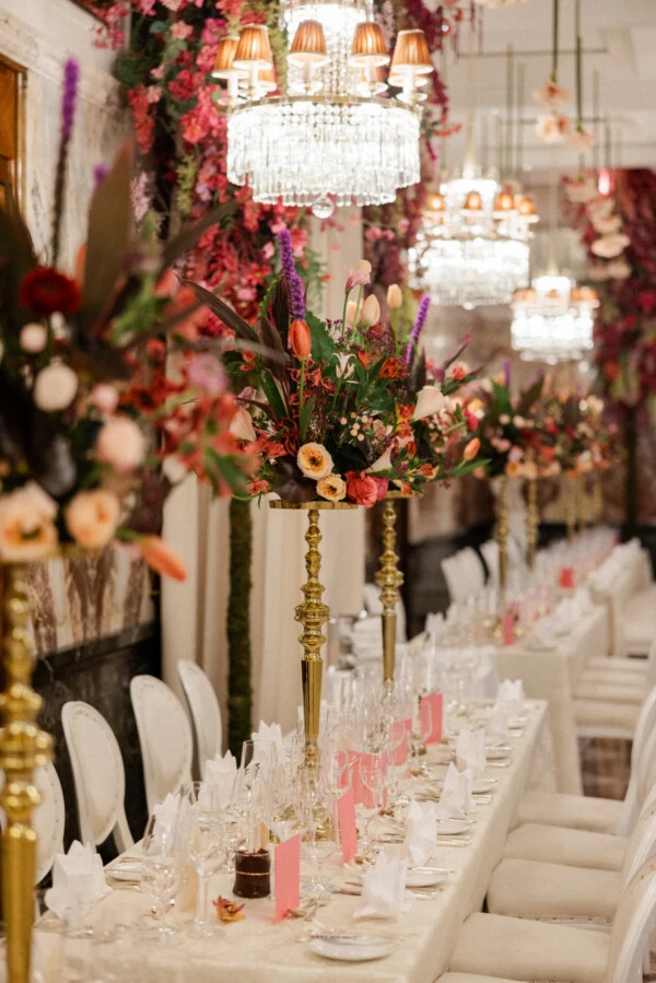 Elegant dinner setting at Hotel Sacher Vienna during Vienna’s ball season with floral arrangements and crystal chandeliers.