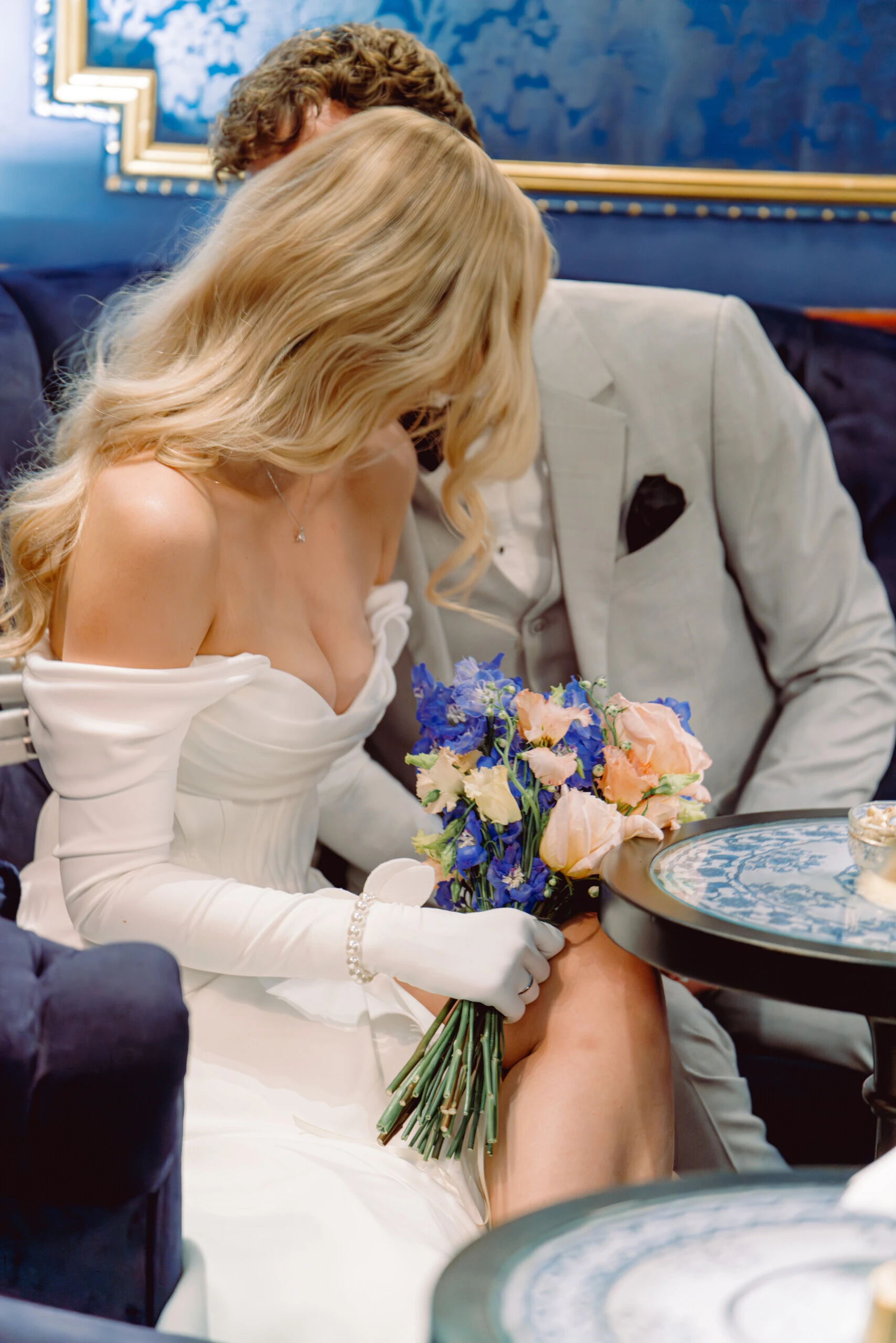 A bride and groom holding a bouquet in the Blaue Bar at Hotel Sacher Vienna.