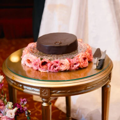 The Original Sacher-Torte as a wedding cake, decorated with a wedding ring and pink floral arrangements, at the Hotel Sacher Vienna.