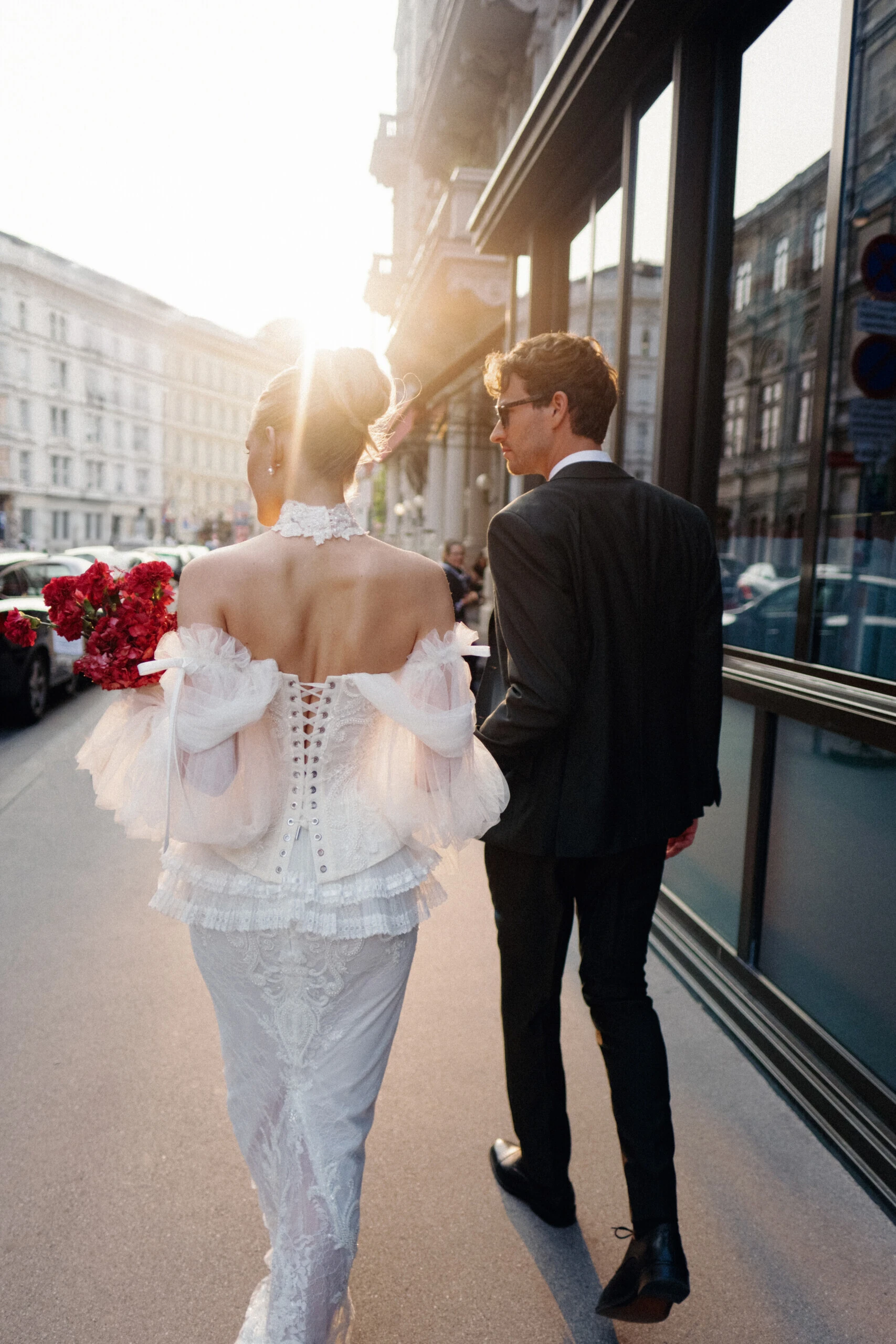 A bride and groom taking a walk in front of the Hotel Sacher Wien in the heart of Vienna.
