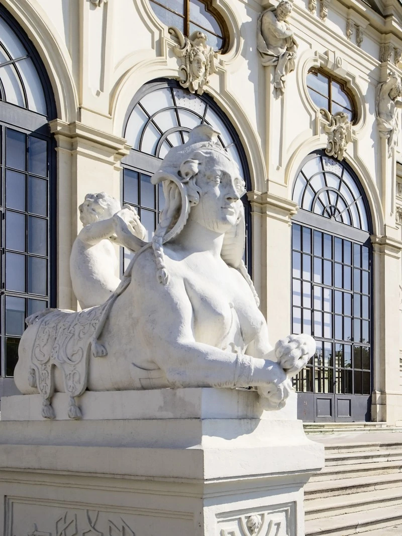 A sphinx sculpture stands guard outside Vienna’s ornate Upper Belvedere Palace.