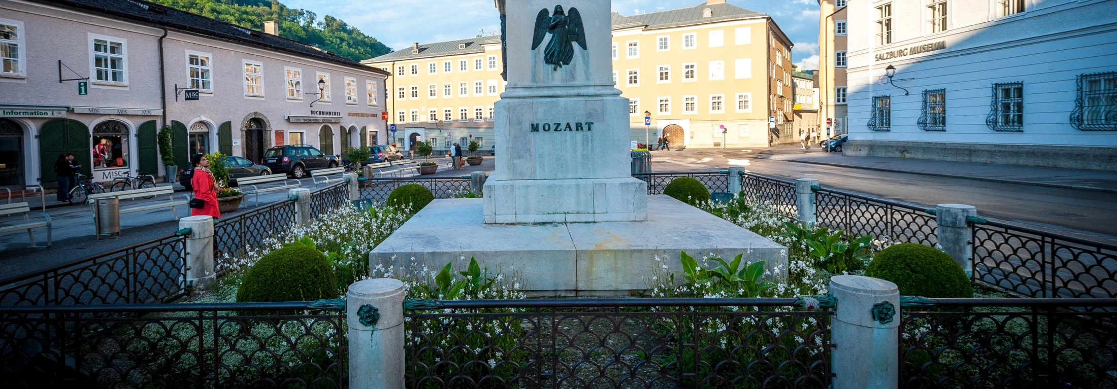 This image shows the Mozartplatz in Salzburg, Austria, with the statue of Wolfgang Amadeus Mozart at its center.