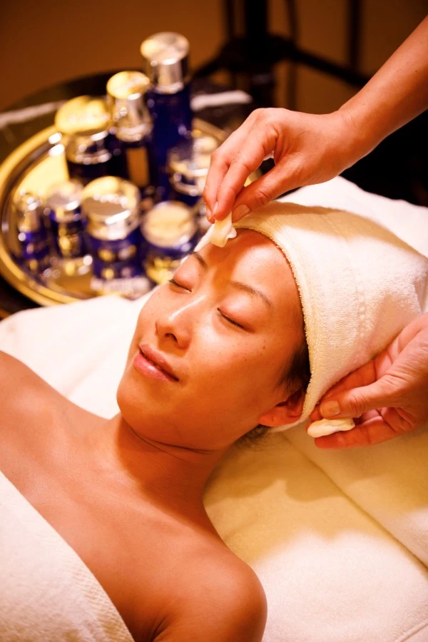 A relaxing facial treatment is being gently applied with premium skincare products.