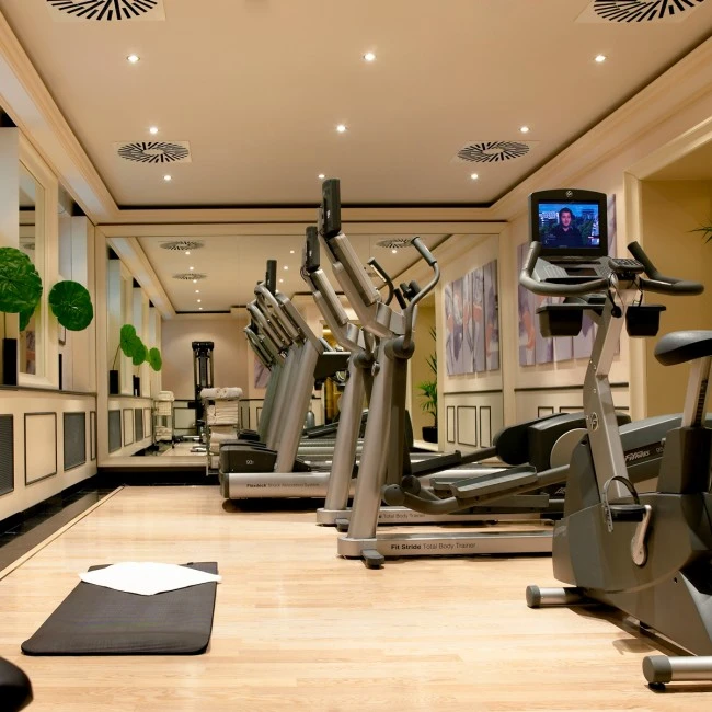 Sacher_Wien_Spa_DaySpa-1 This is a modern fitness room with cardio machines and mirrors.