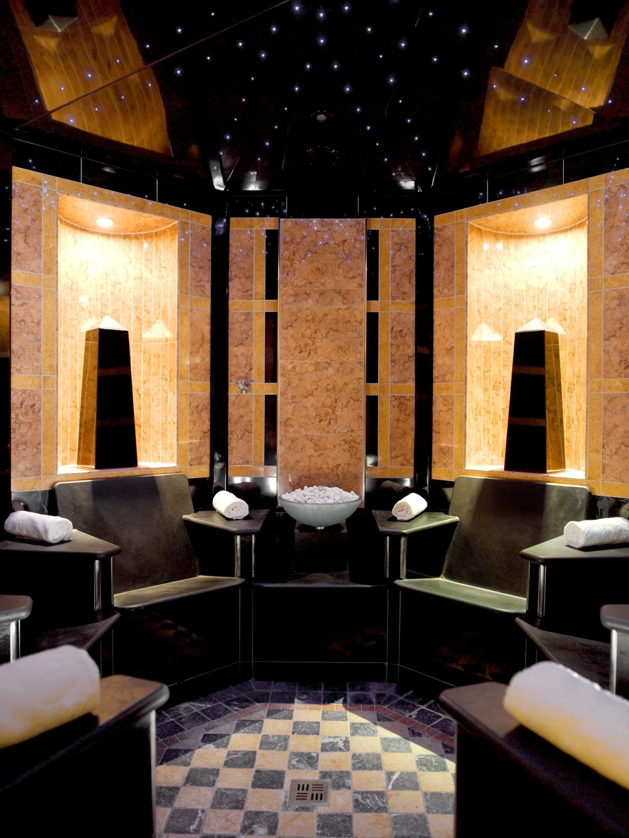 This is a luxurious steam room with star-like lights on the ceiling.