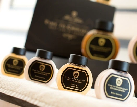 Luxury chocolate-scented toiletries elegantly displayed.