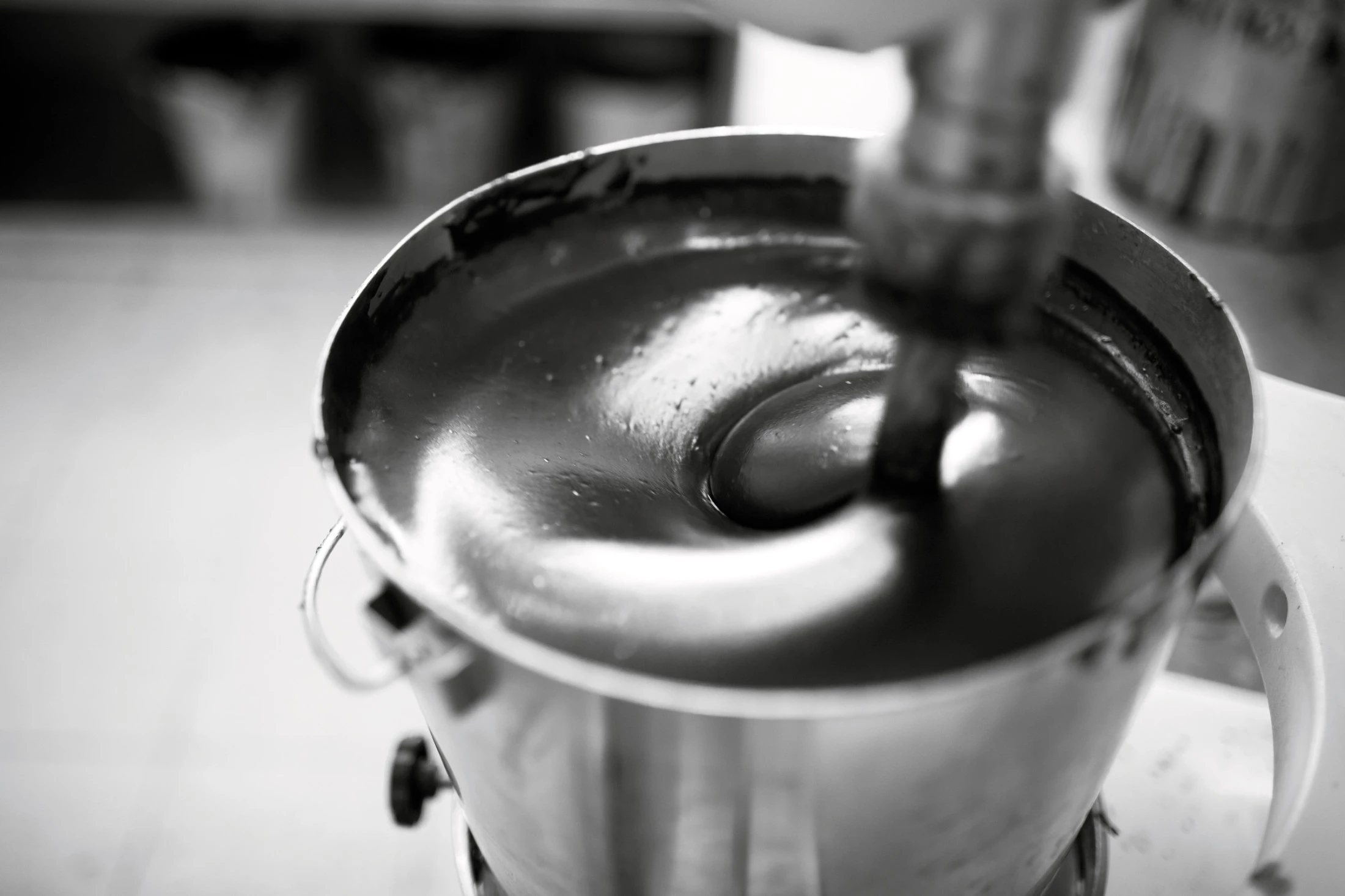 A rich, velvety chocolate mixture swirls hypnotically in a professional mixer, capturing the artistry of dessert creation.