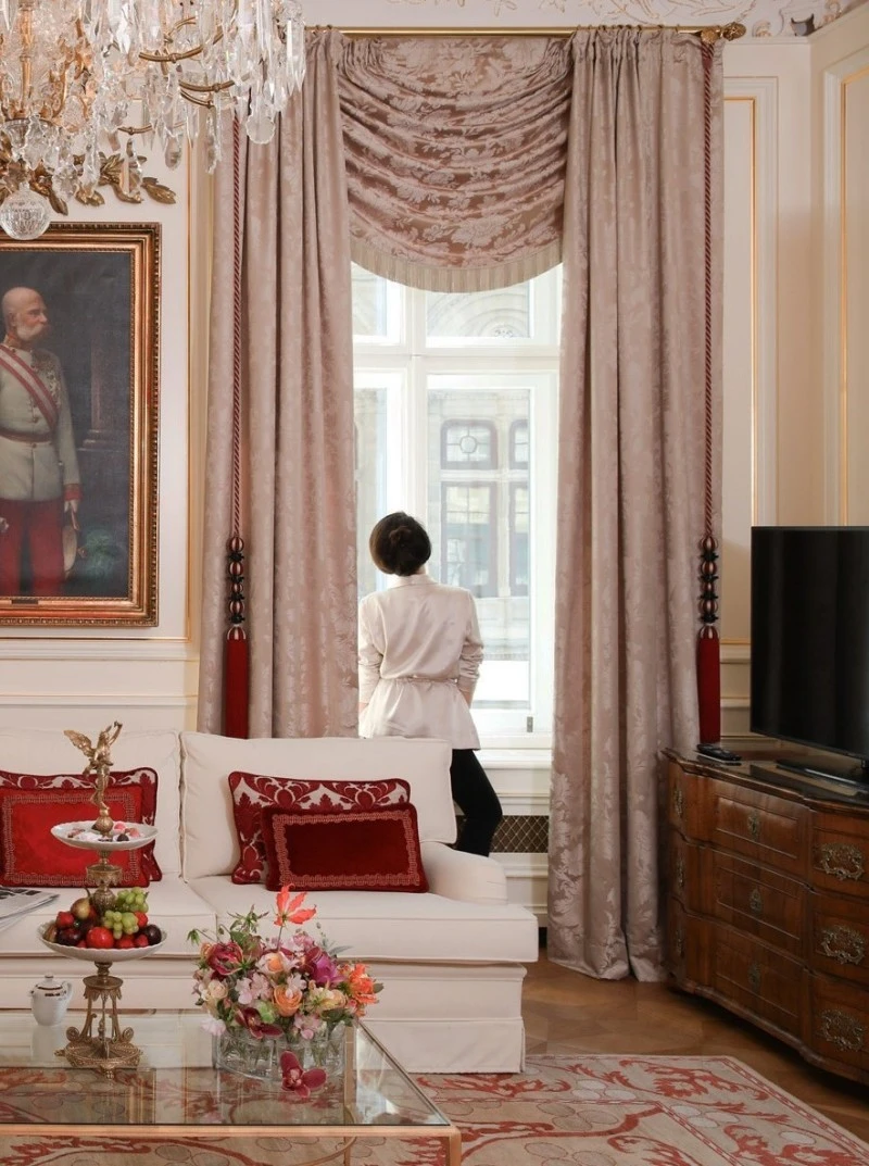 A guest takes in the historic charm of Vienna from the elegance of a Hotel Sacher suite.