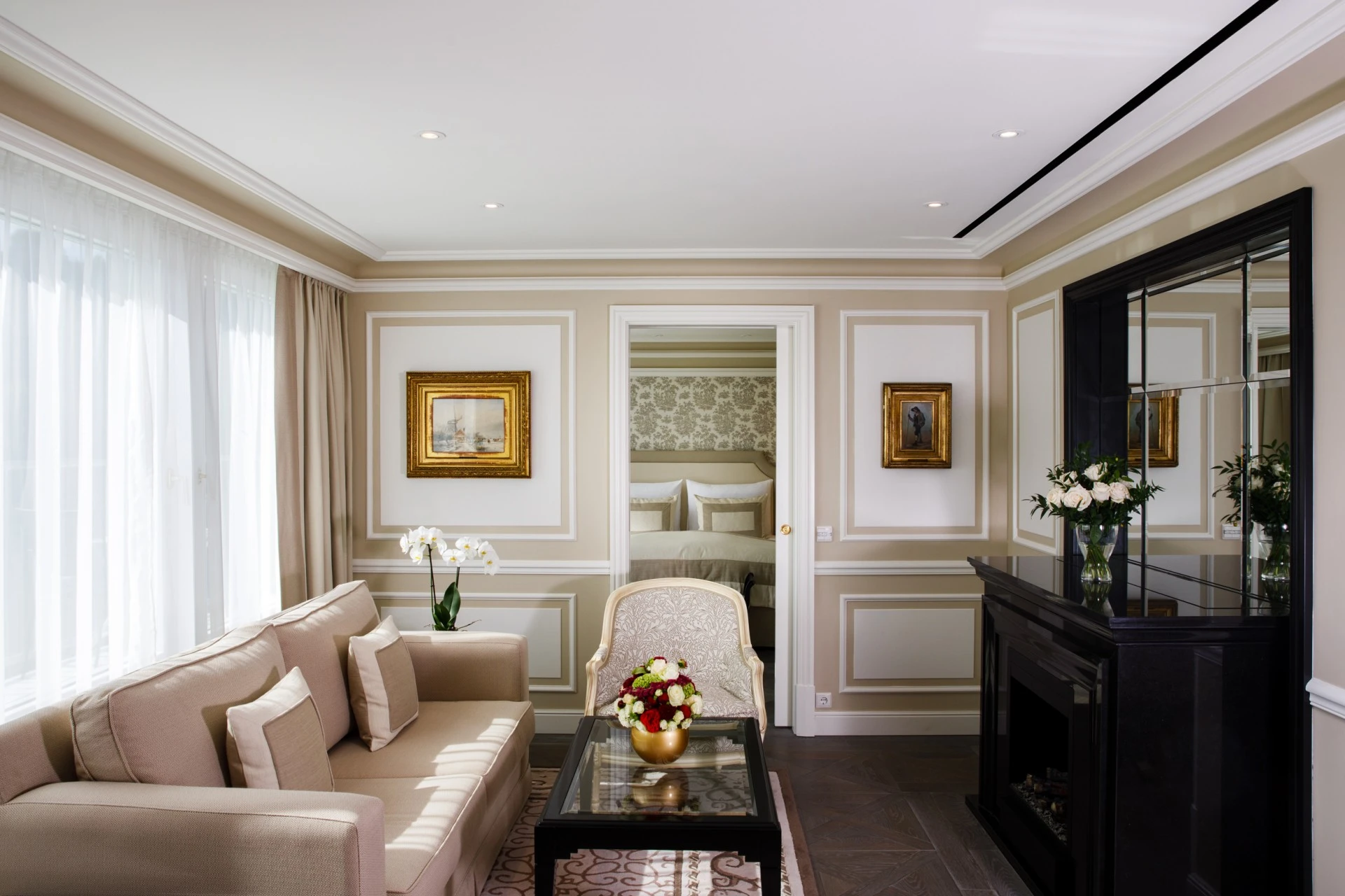 This is an elegantly appointed suite at Hotel Sacher Salzburg, featuring classic furnishings, soft ambient lighting, and refined décor that exudes timeless luxury.